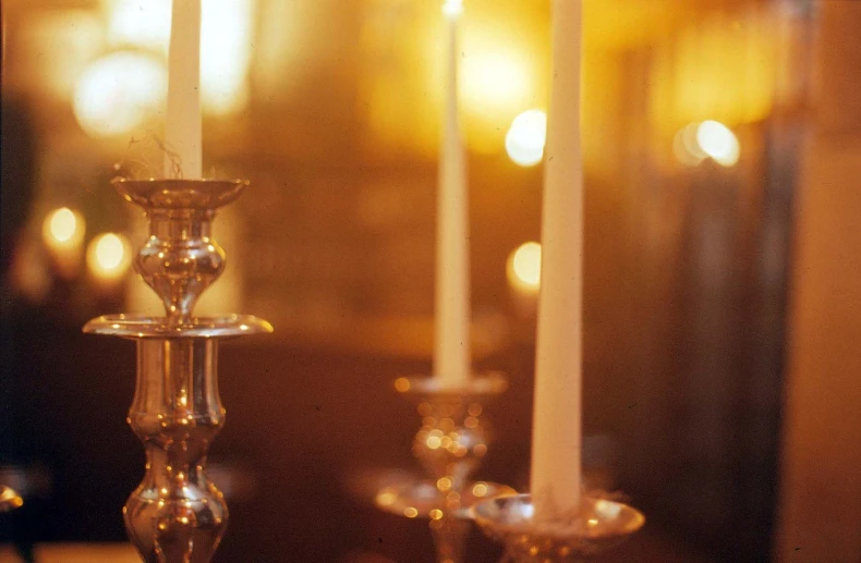 two candles are burning in a church as the others look on