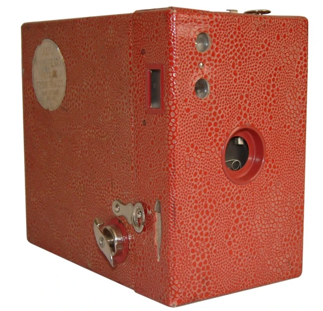 an orange and gold box shaped object with holes and handles