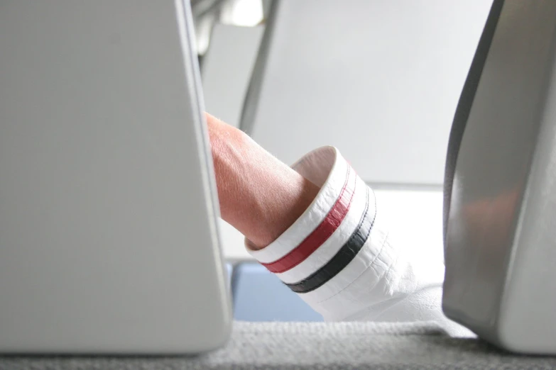 a person using a computer at their feet and their socks