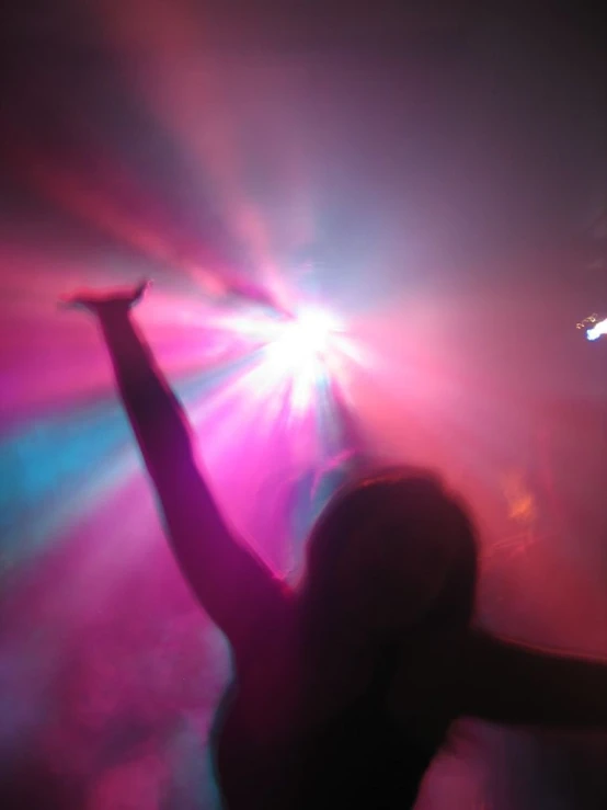 a woman dancing in front of a white disco ball