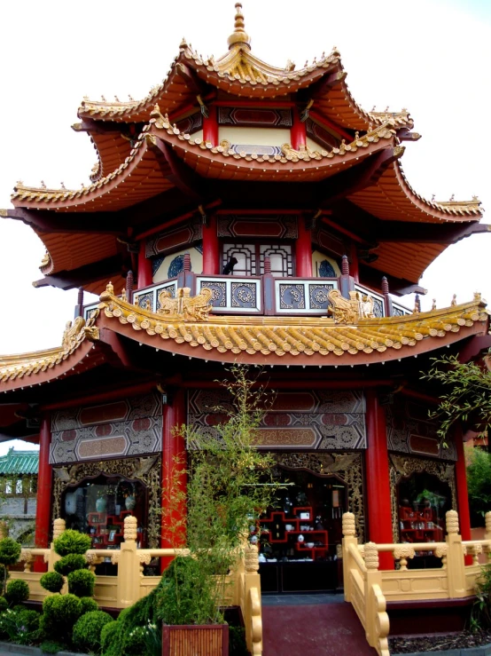 a traditional oriental building with plants around the courtyard