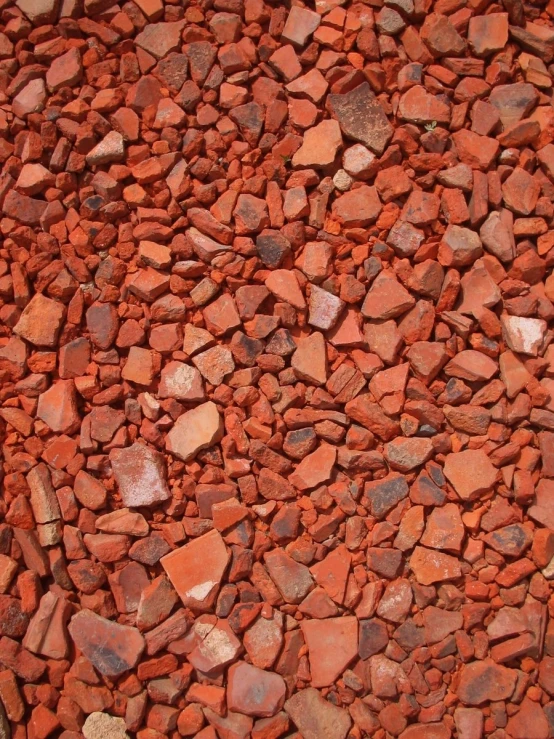 close up of red rocks laid over looking a small patch of land