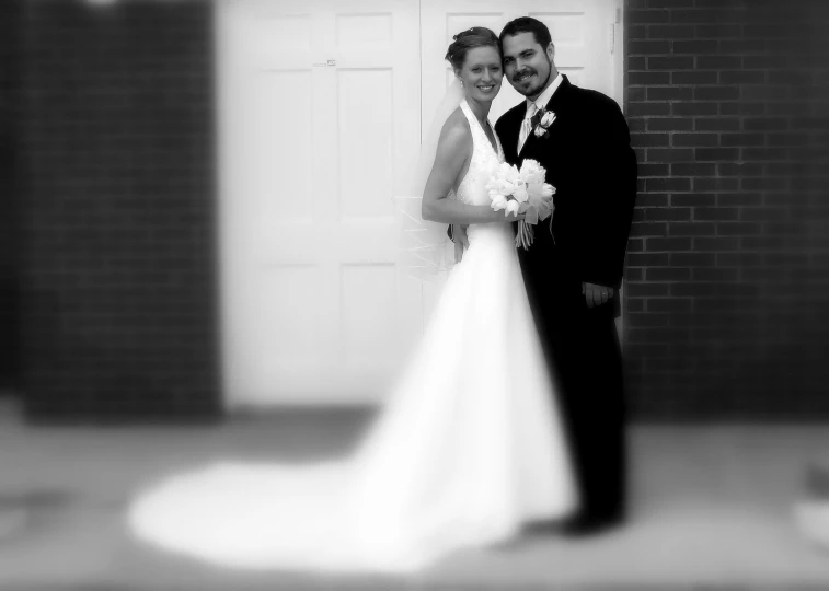 a black and white po of a bride and groom