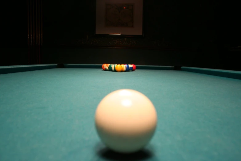 a pool ball with a cue resting on it
