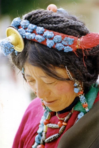 an older woman with ids and beads wearing a head piece