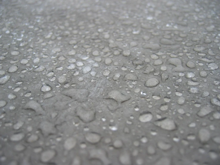 wet concrete has small drops of water and a star