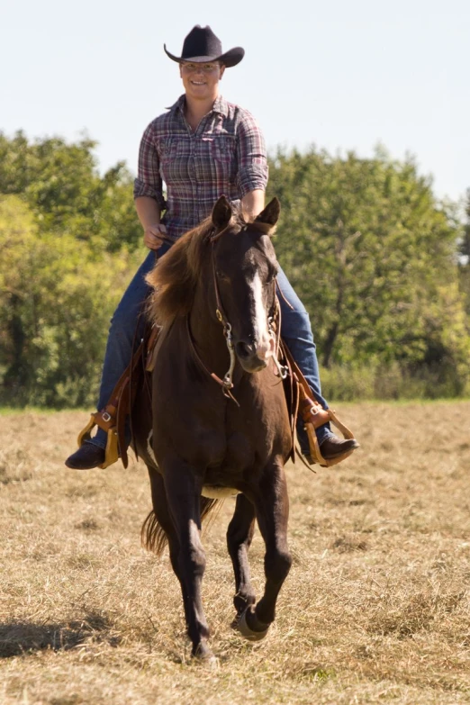 a man rides a horse in an open field