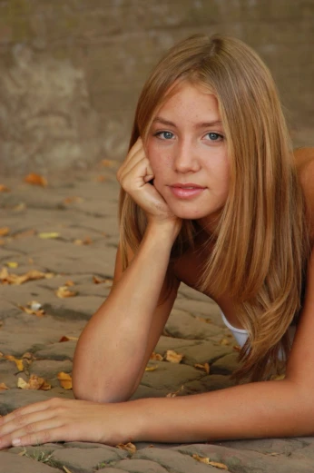 a beautiful blond haired woman laying on the ground