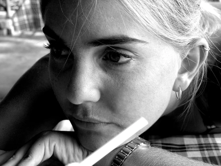 a girl holds a toothbrush over her face