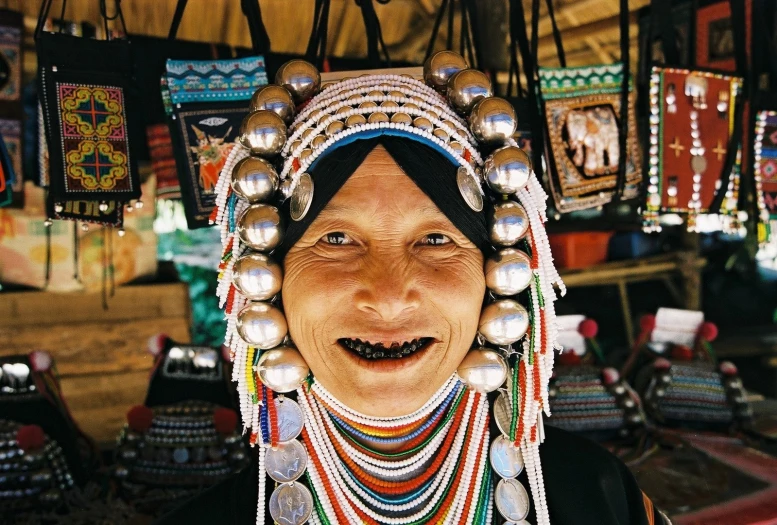 a woman wearing jewelry and smiling at the camera