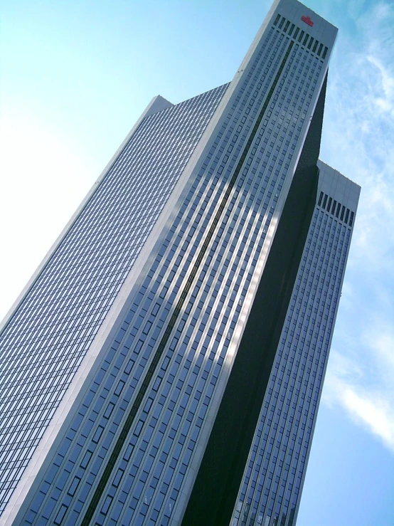 the tall building is surrounded by clouds