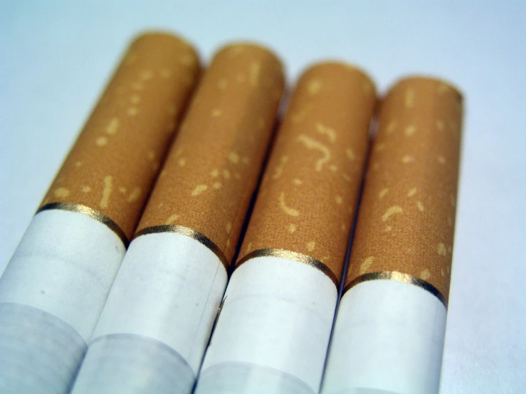 three row of cigarettes sitting on a white table