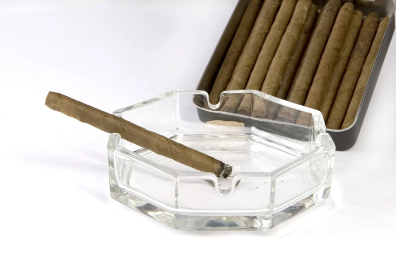 an ashtray with a cigar and a cigar in it