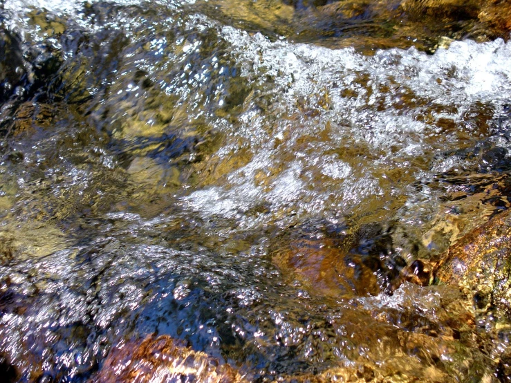 a river is flowing over some rocks