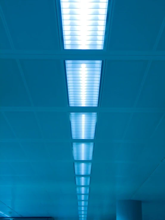 a long hallway has blue lights in it