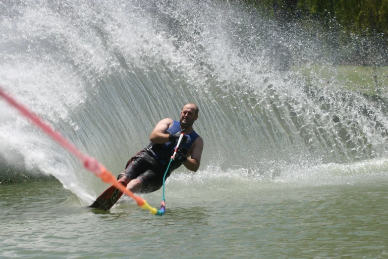 a man standing in water on top of a ski board