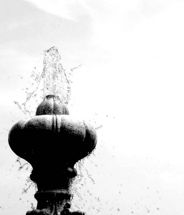 a black and white pograph of a water fountain