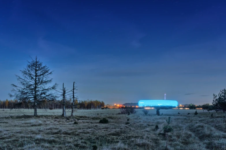 the blue building is sitting out in the wilderness