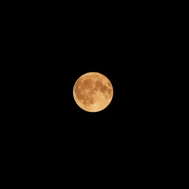 the full moon shines in a clear night sky