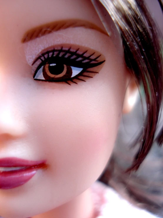 close up of doll face with makeup on white dress