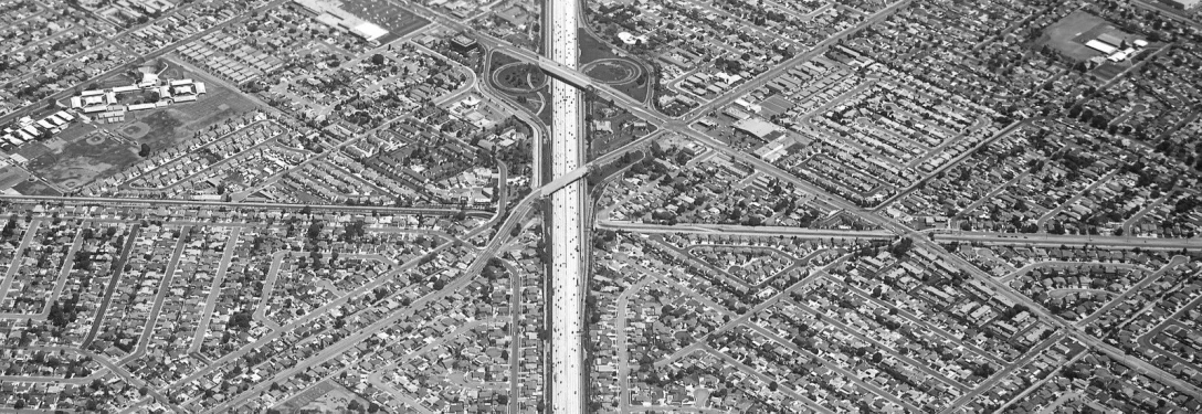 an airplane flying over an intersection in the city