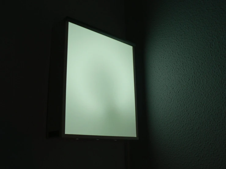 a dark room is seen with a window lit by the light