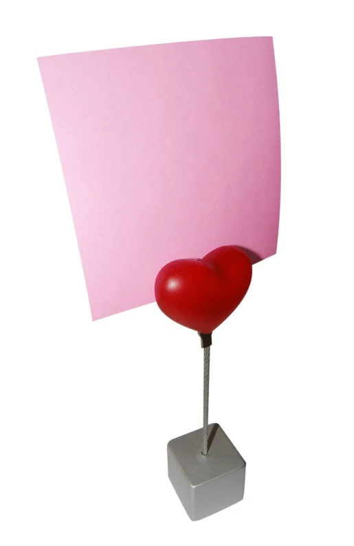 a red heart with a red heart on it, placed next to a blank card