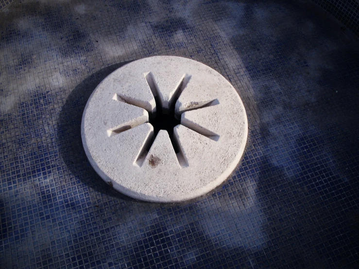 a small white round on top of blue tile