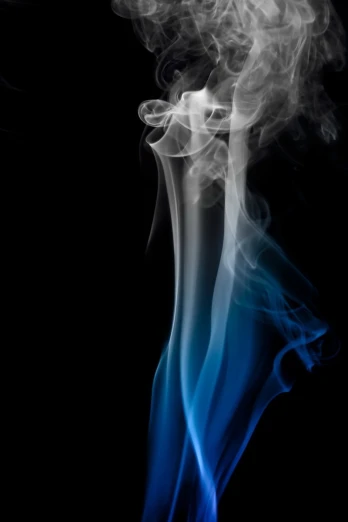 smoke against a black background with a blue tail