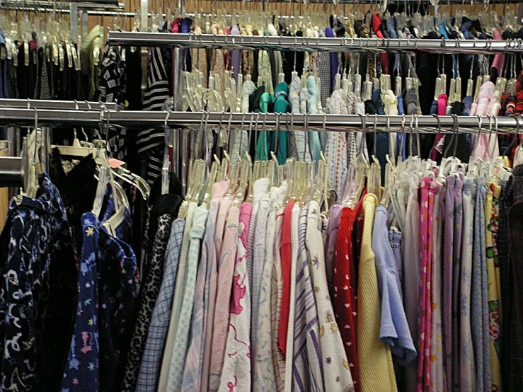 there are racks of scarves of different colors and styles