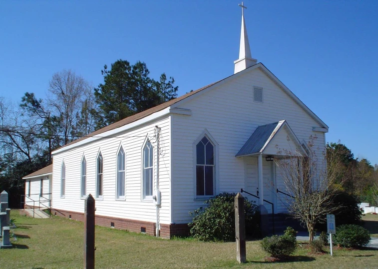 a large church with a white steeple and a clock tower