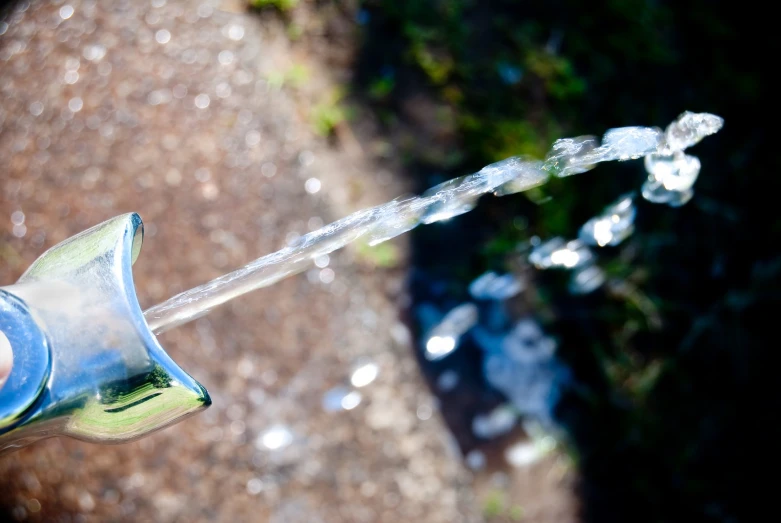 water being sprayed out from a hose with some liquid