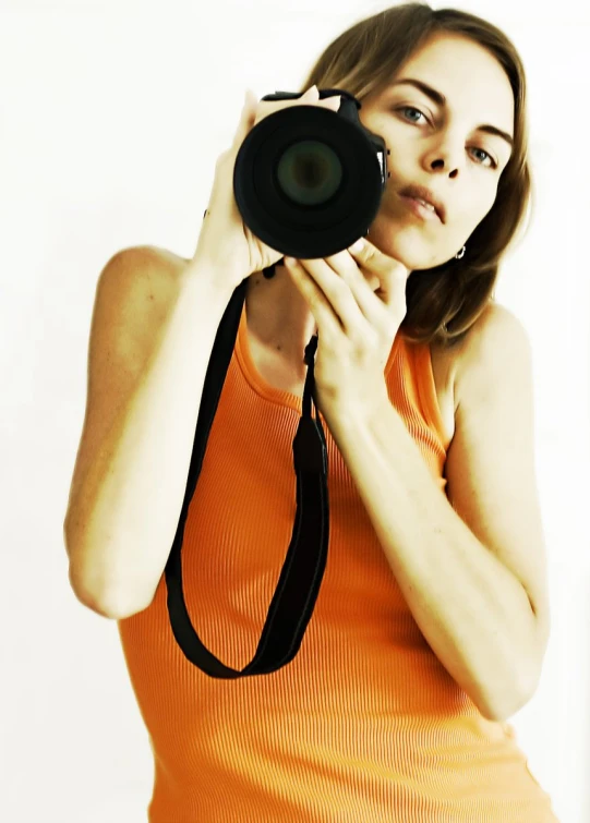 a woman holding up a camera to take a picture