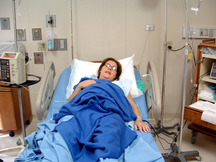 an overweight woman laying in a hospital bed