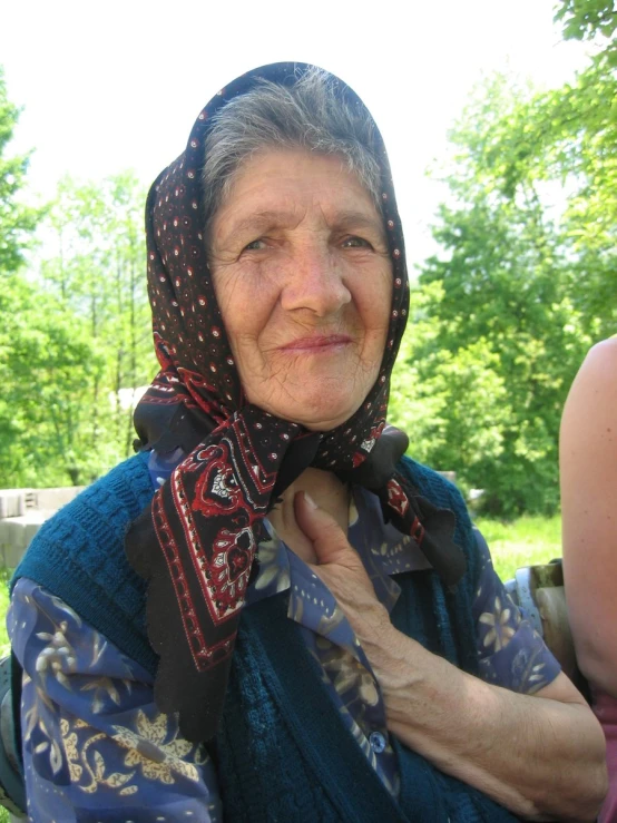 a woman wearing a scarf and headscarf is posing for a po