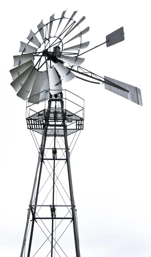 a windmill sitting next to a power pole