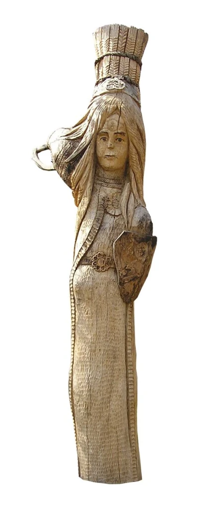 a wooden statue with an indian girl holding a bird