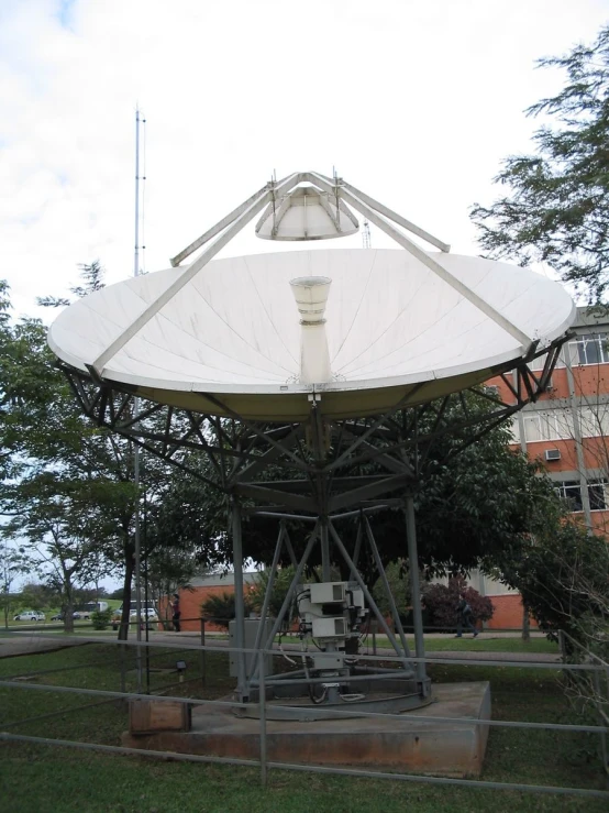 an old white tent set up near some trees