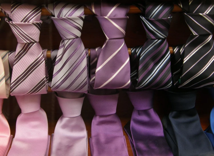 a collection of multicolored ties laid out in a row