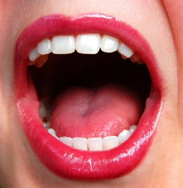a close up po of a child's mouth with a tongue