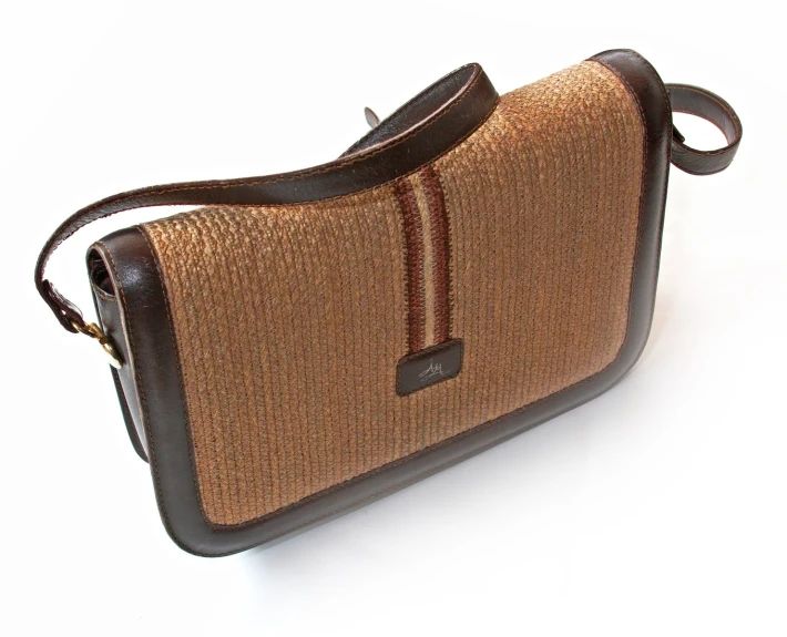 a brown and black purse that has handles on the inside