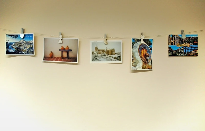 pictures hanging on a line above an open room