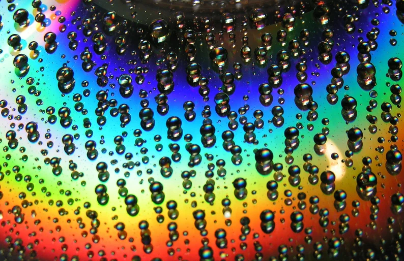 droplets are on a rainbow colored glass