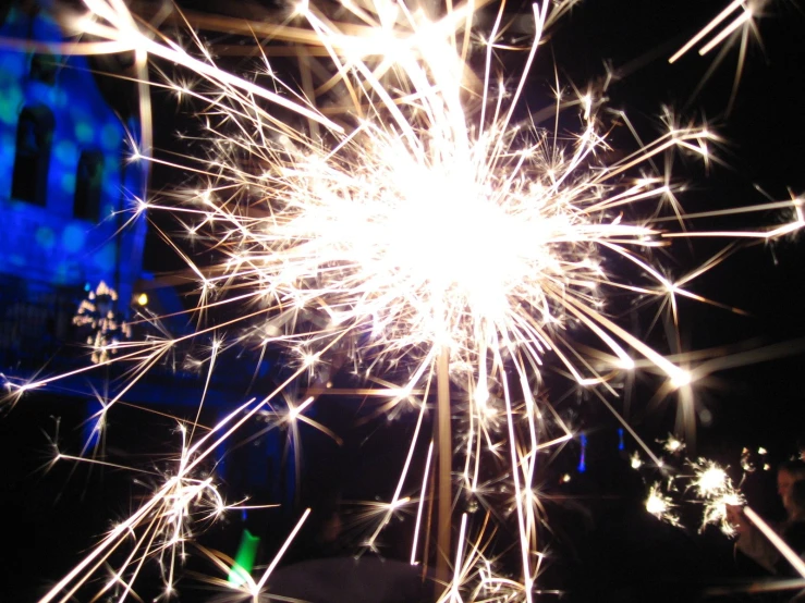 firework with castle in the background lit up at night