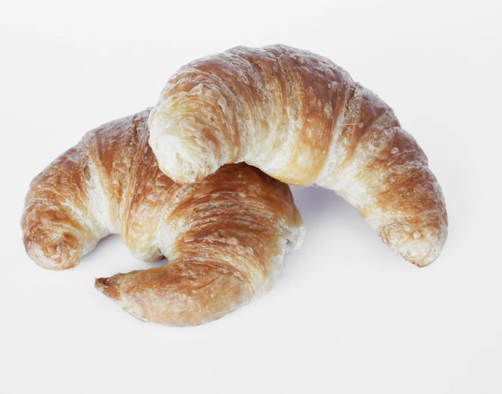 a close up of two croissants on a table