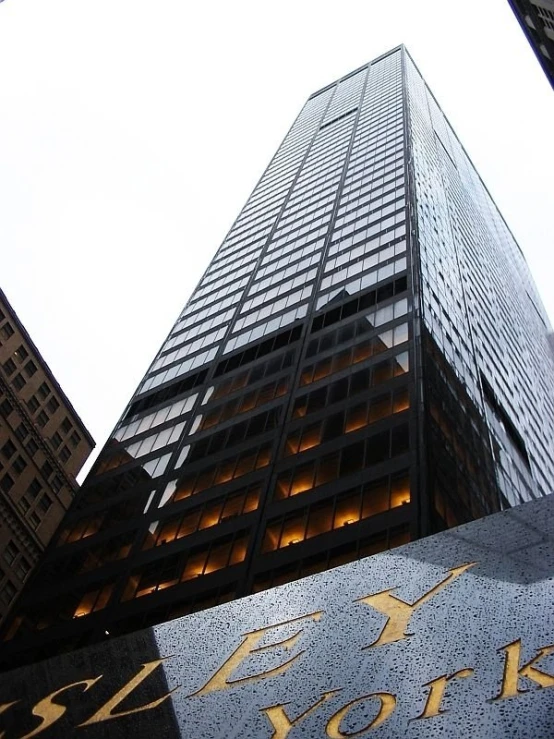 a high rise building with windows and light reflecting off of it