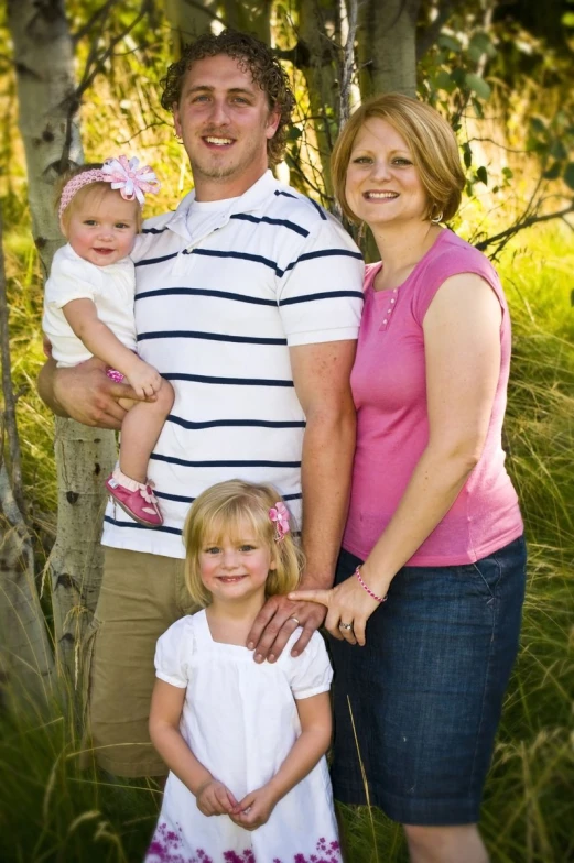 a couple and their daughter posing for a po