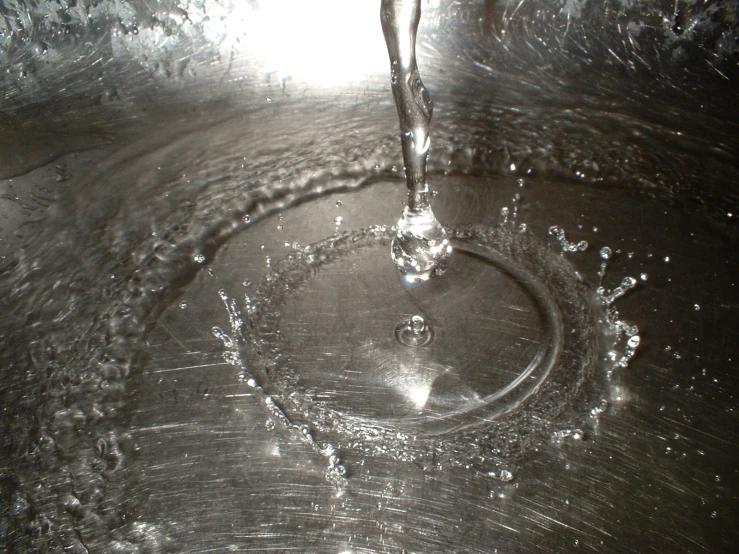 water spilling into the sink, making the water look like it's coming out of the basin