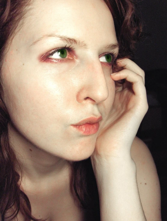 a woman with green eyes and brown hair