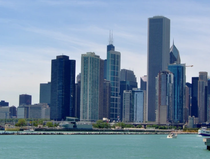 a view of some tall buildings from across the water